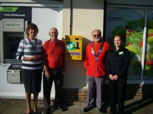 Lions Club members at West Moors Co-op with local represenatives after the installation of the defibrillator